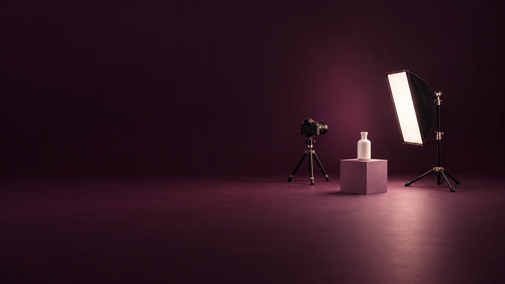 A camera on a tripod, an ivory bottle on a mauve plinth and a studio softbox. - Commercial Photography Services Meta ads research by Madgicx Labs