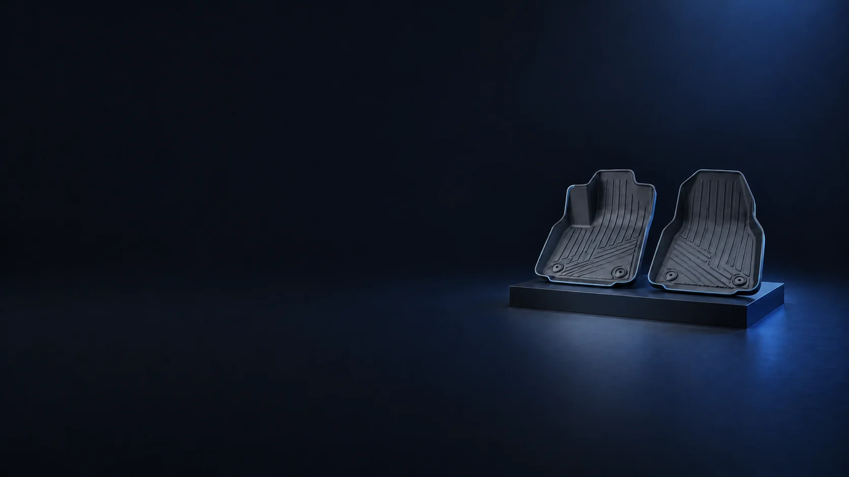 Two graphite rubber footwell liners with raised edges and channels on a low dark platform. - Interior Accessories Meta ads research by Madgicx Labs