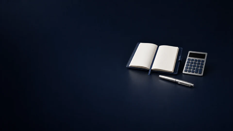 An open blank navy ledger beside an unmarked calculator and a capped silver pen. - Business & Consulting Services Meta ads research index
