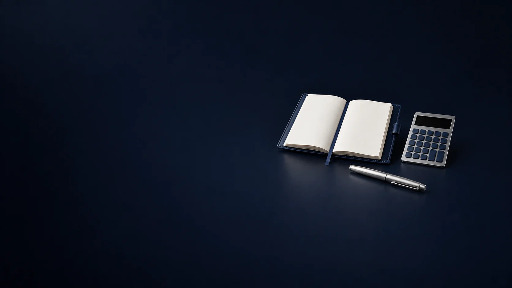 An open blank navy ledger beside an unmarked calculator and a capped silver pen. - Financial Advisory Consulting Meta ads research by Madgicx Labs