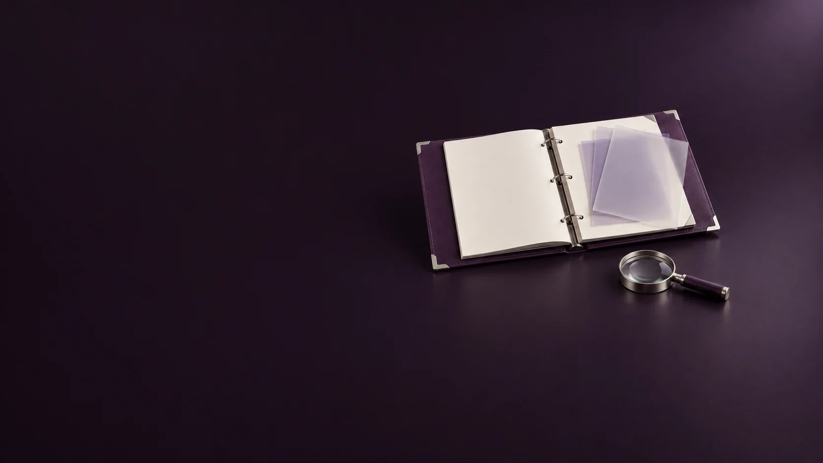 An open purple report binder with blank pages, translucent overlays and a silver magnifying glass. - Analytics & Reporting Tools Meta ads research by Madgicx Labs