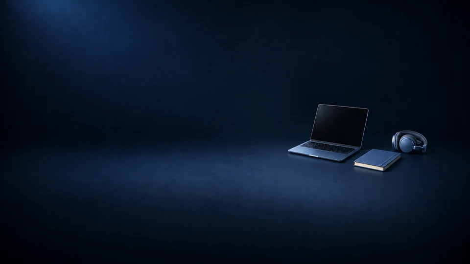 An open laptop with a dark screen beside a blue notebook and folded blue headphones. - Educational Services & Training Meta ads research index