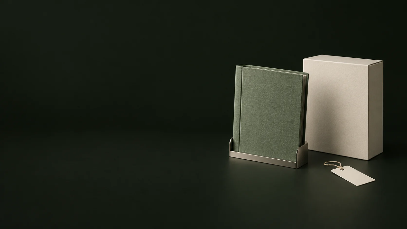 A green document binder in a nickel cradle beside a plain ivory box and blank tag. - Green Certification Services Meta ads research by Madgicx Labs