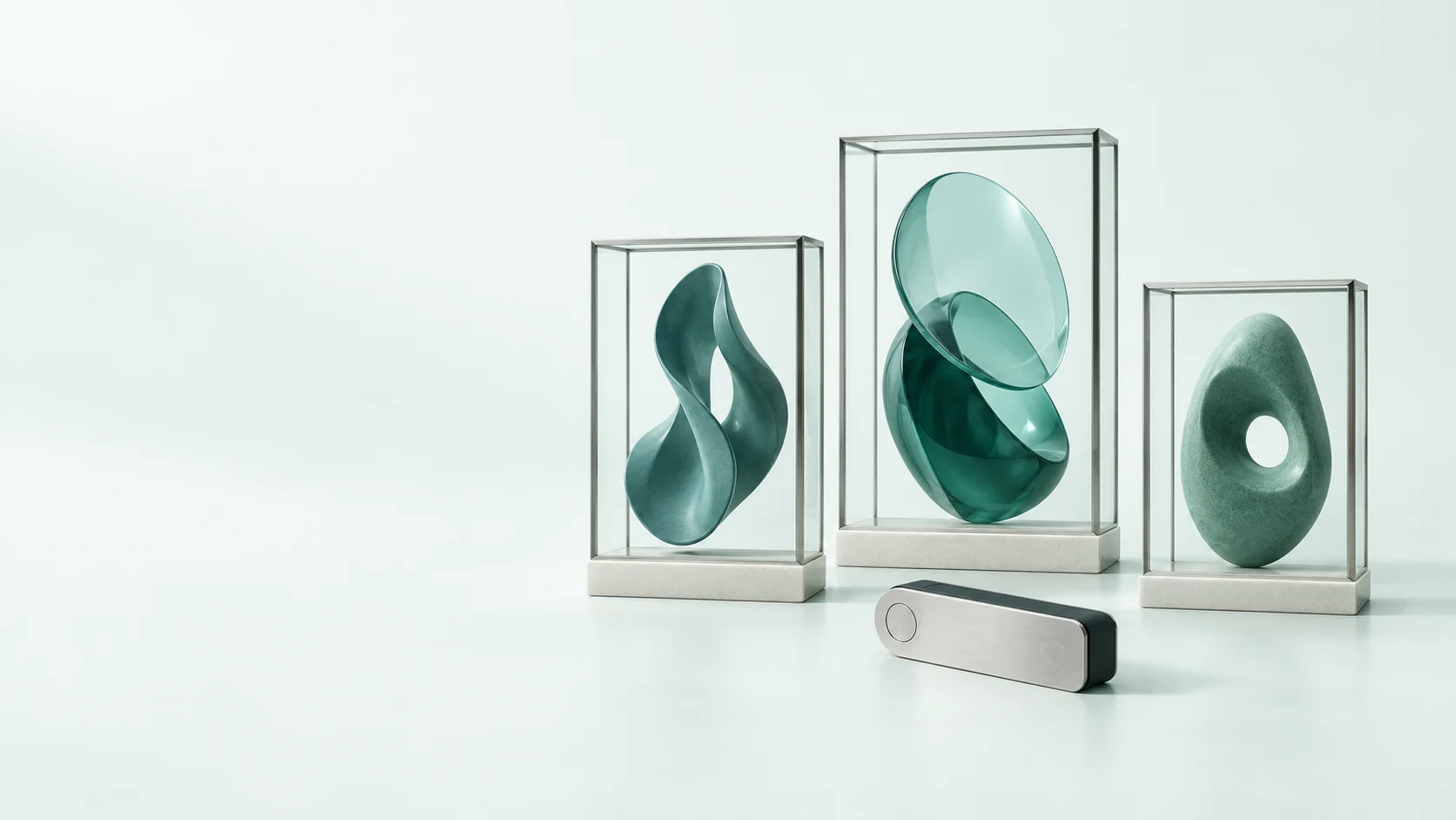 Three original abstract artworks in clear display frames beside an unmarked wallet device. - NFT Digital Asset Marketplaces Meta ads research by Madgicx Labs