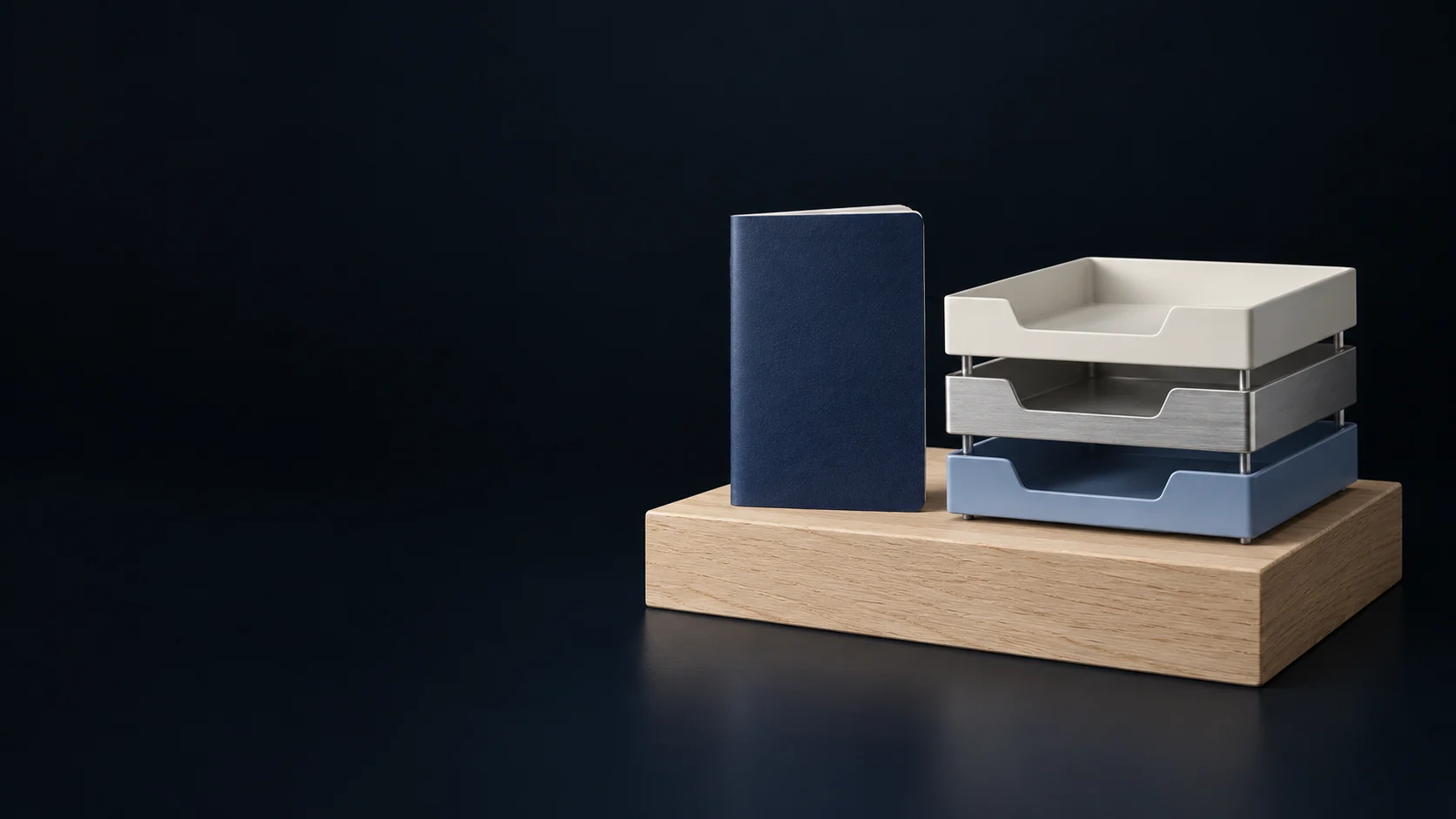 A blank navy booklet beside three service trays on a low pale oak counter block. - Civic & Administrative Services Meta ads research by Madgicx Labs