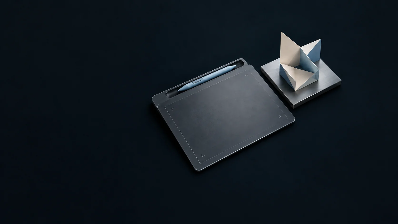 A pen tablet and blue stylus beside a folded-paper project model on a metal base. - Freelance Gig Platforms Meta ads research by Madgicx Labs