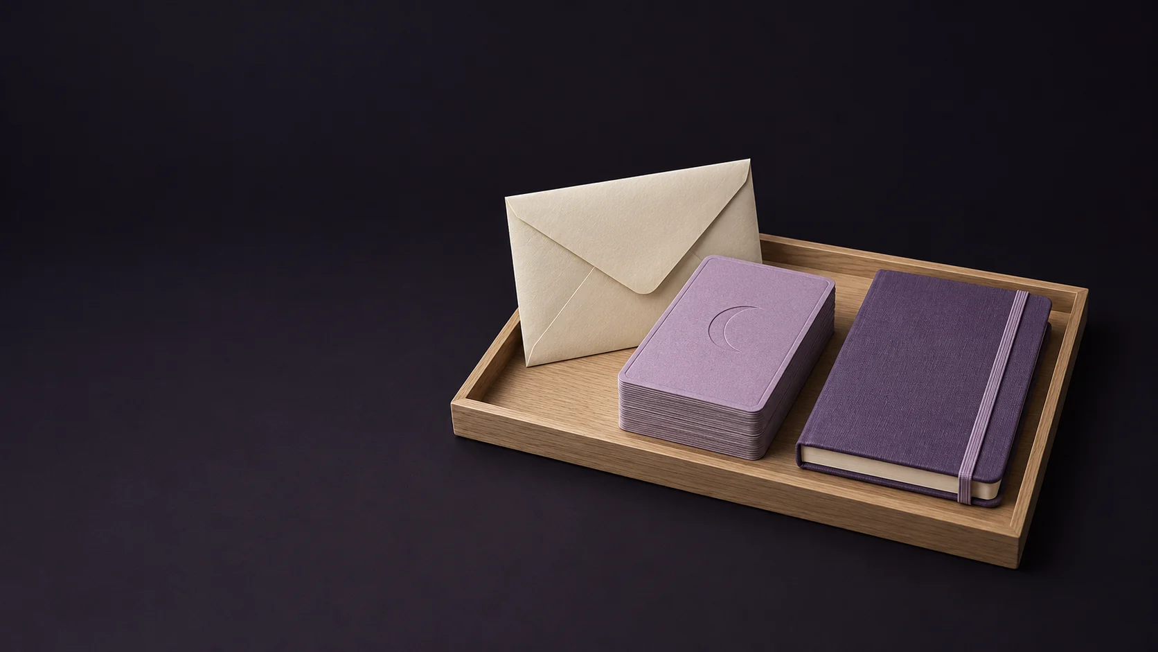 A mauve card deck with plain crescent backs beside a blank ivory envelope and amethyst practice notebook in an oak tray. - Tarot Card Readings Meta ads research by Madgicx Labs