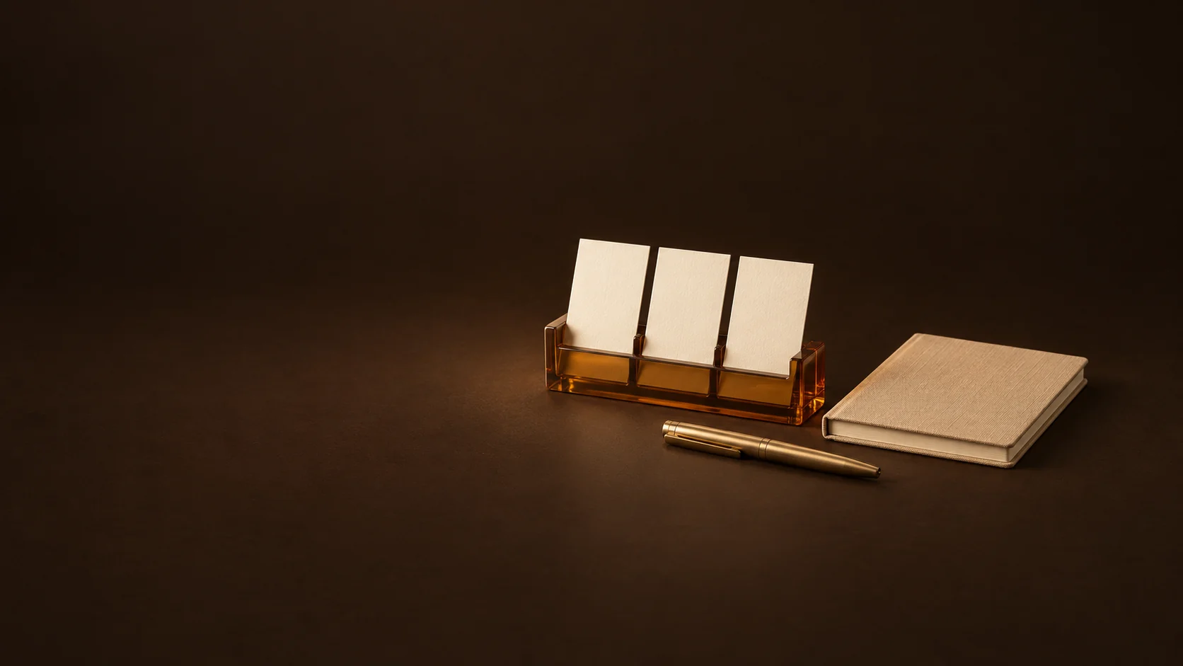 Three blank appointment cards in an amber holder beside a camel notebook and brass pen. - Career Development Coaching Meta ads research by Madgicx Labs