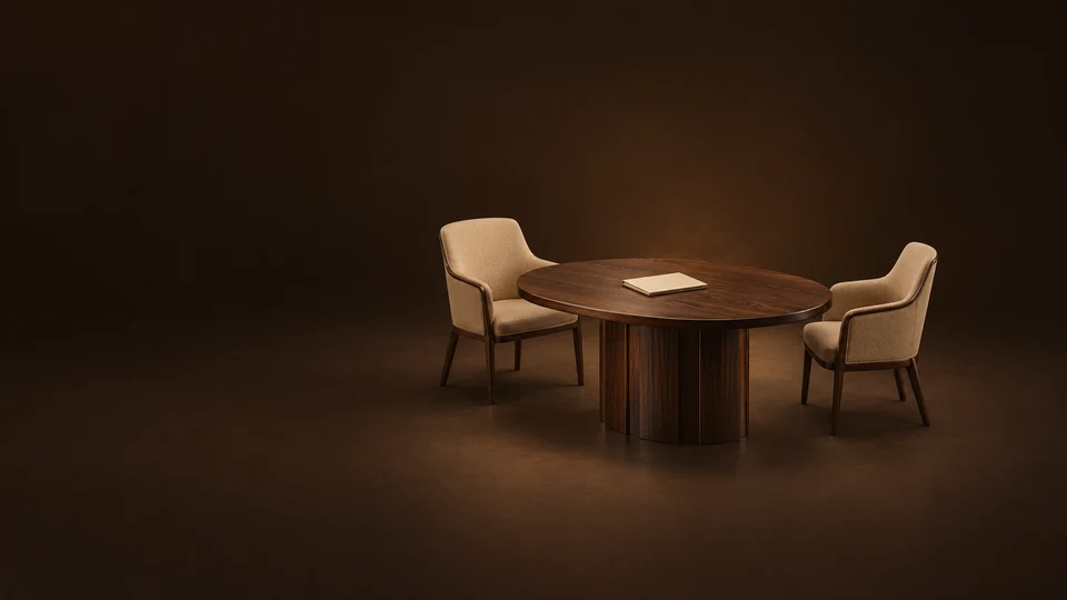 Oval oak meeting table with two empty camel chairs and a plain engagement folder. - Personal Coaching & Development Meta ads research index