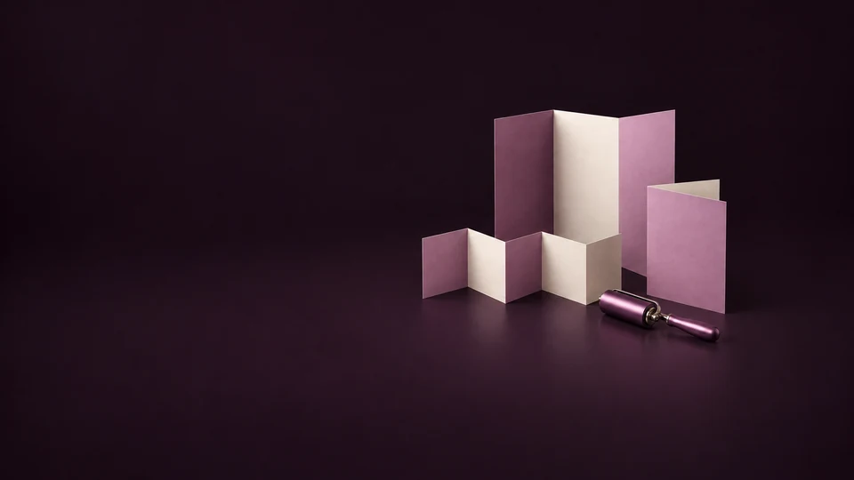 A trifold brochure, accordion fold and half-fold sheet stand beside an orchid inking roller. - Printing & Publishing Services Meta ads research index