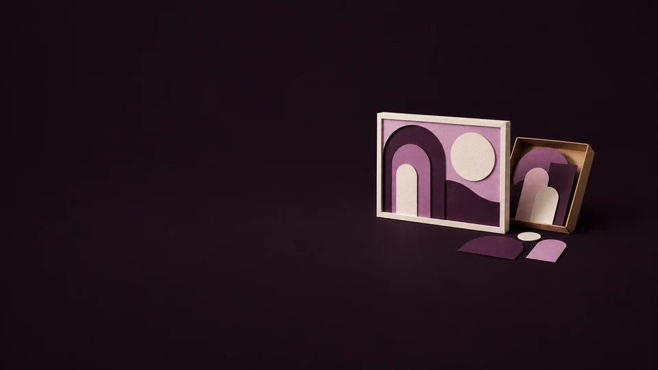 A framed abstract composition of paper arches and circles beside a tray of separate cut-paper pieces. - Stock Media & Content Platforms Meta ads research index